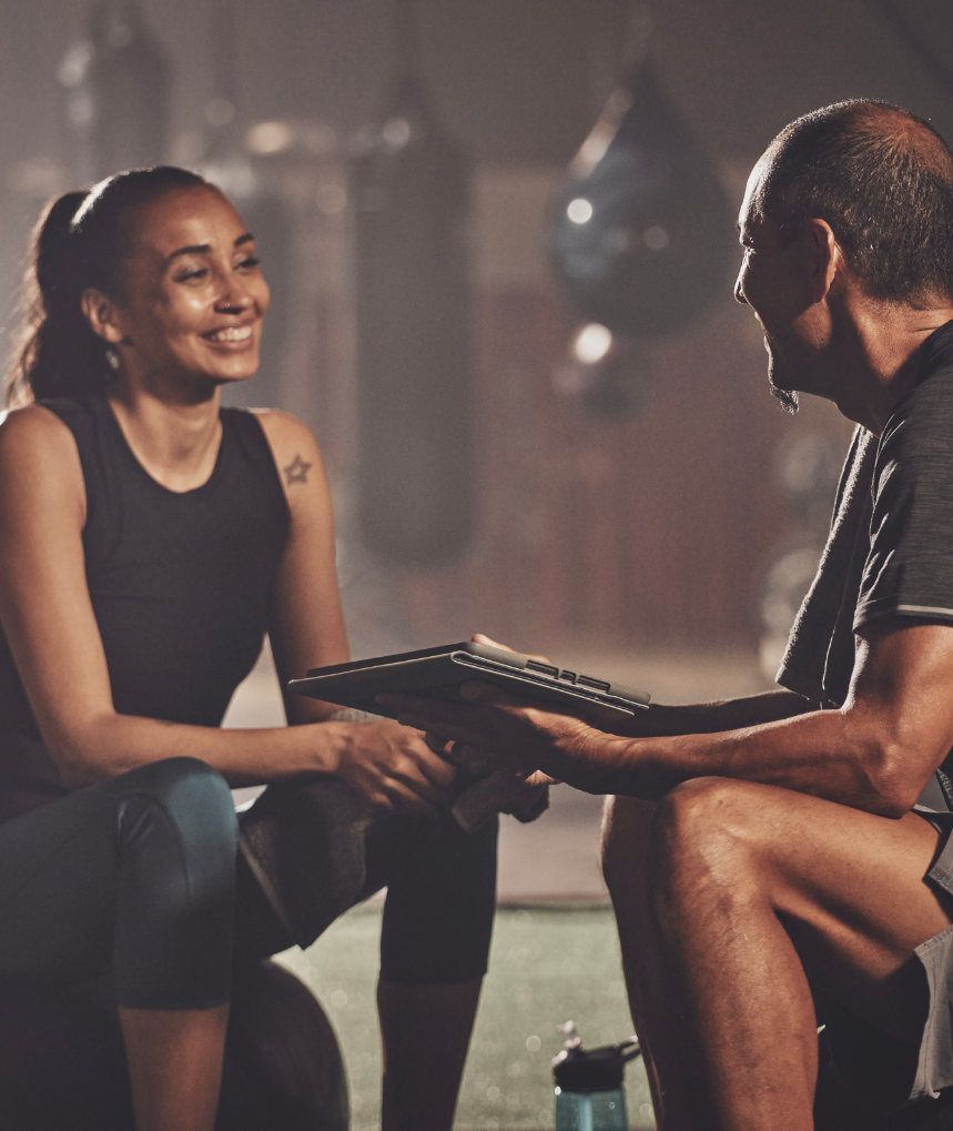 Woman sitting and smiling at her trainer