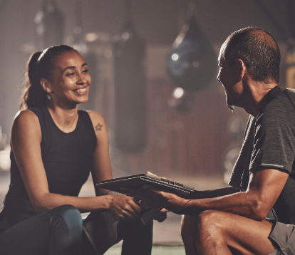 Woman sitting and smiling at her trainer
