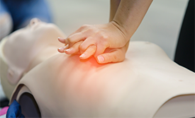 Person doing CPR on a CPR dummy